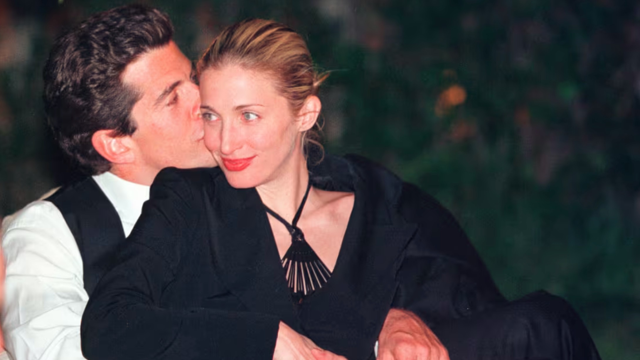 JFK Jr. sweetly planted a kiss on his wife's cheek at the White House Correspondents dinner on May 1, 1999.